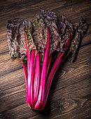 Red Swiss chard on a wooden background