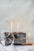 Wooden box and lit candles