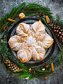 Sweet Christmas bread in a star shape with cinnamon and almonds