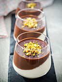 Coconut panna cotta with chocolate ganache layered in glasses