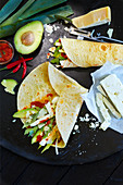 Wraps with avocado, rocket, cheese and chilli