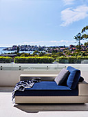 Day bed with blue overlay on roof terrace