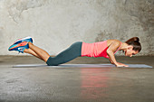 A young woman performing a simple push-up