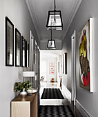 Image gallery in the hallway with light gray walls