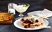 Cinnamon waffles with spiced red wine cherries and whipped cream