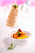 Papaya and orange sorbet in a glass with an exotic fruit salad