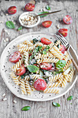 Fusilli pasta with spinach, asparagus, tomatoes, basil, pine nuts and grated parmesan cheese