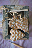 Heart-shaped pendants with waffle structure on top of box with peeling paint