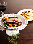 Roasted saddle of venison with savoy cabbage and chanterelle mushrooms and blueberry pancakes