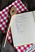 Handwritten recipe for bread patties in open book