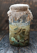 Pickled Lactarius piperatus mushrooms with onion, pepper and garlic in a jar