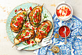 Baked aubergine, stuffed with meat and lenils