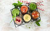 Colourful smoothies with fruit, vegetables and herbs