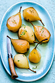 Poached pears on a blue plate