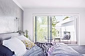 View of the balcony from the bedroom in white and gray