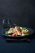 Colourful tomato salad with turkey skewers