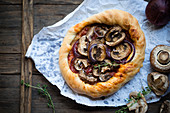 A vegan pizza with mushrooms and red onions