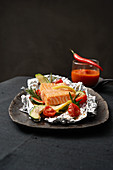Foil roasted salmon with a pepper and tomato dip