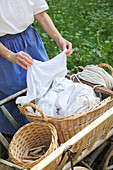 Woman hanging up laundry hand-washed using traditional methods