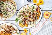 Grilled chicken kebabs with peaches and couscous salad