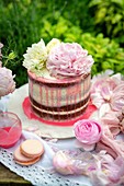 Strawberry cake with peonies on a garden table