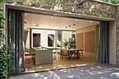 View from terrace looking into open-plan kitchen with dining area