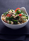 White Bowl of Tabouli Salad with Mint, Parsley, Tomatoes and Lemon