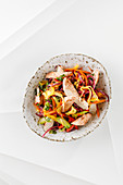 An oriental rainbow salad with tandoori chicken