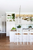 Ladder as hanging storage in the open country kitchen