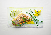 Food art: bass with lime, Thai asparagus, sesame seeds and mango sauce on a page of watercolour