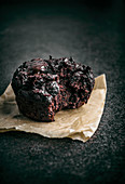 Dark chocolate beet muffin on parchment paper