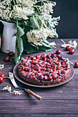Cherry chocolate cake on a serving plate