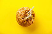 Coconut Water in natural coconut healthy drink on yellow background