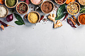 Healthy ingredients and spices on rustic murble background: Coconut shell bowls with paprika salt parsley, pepper, brown rice, couscous, red bean and lentis