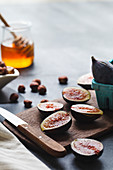 Figs and honey on cutting board