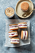 Vanilla, blueberry ice cream sandwiches and iced coffee on the table