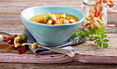 Potato soup with curry, crispy bacon and croutons