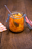 Preserved apricots with peach liqueur in a flip-top jar