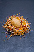 A foie gras egg with crispy organic vegetables, peach coulis and porcini mushrooms