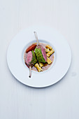 Saddle of milk-fed lamb with a salted almond crust, gorgonzola and rosemary pasta and a tamarind and mustard sauce