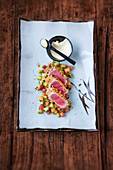 Tuna in a crispy coating on a watermelon and cucumber relish with sesame seed mayonnaise