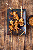 Chicken satay in a crispy pasta coating with peanut sauce