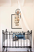 Black crib with canopy and dream catcher