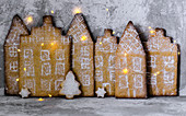 Gingerbread city with lights on concrete background