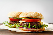 Classical burger with grilled meat, tomatoes, cheese, onion, cucumber and lettuce