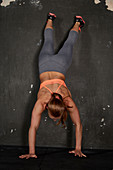 A young woman performing a wall climb