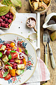 Tomato salad with raspberries, onions and croutons