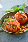 Tomatoes filled with minced meat and peppers served with chanterelle mushrooms