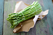 A bunch of green asparagus on paper