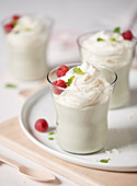White chocolate mousse with raspberries in dessert glasses